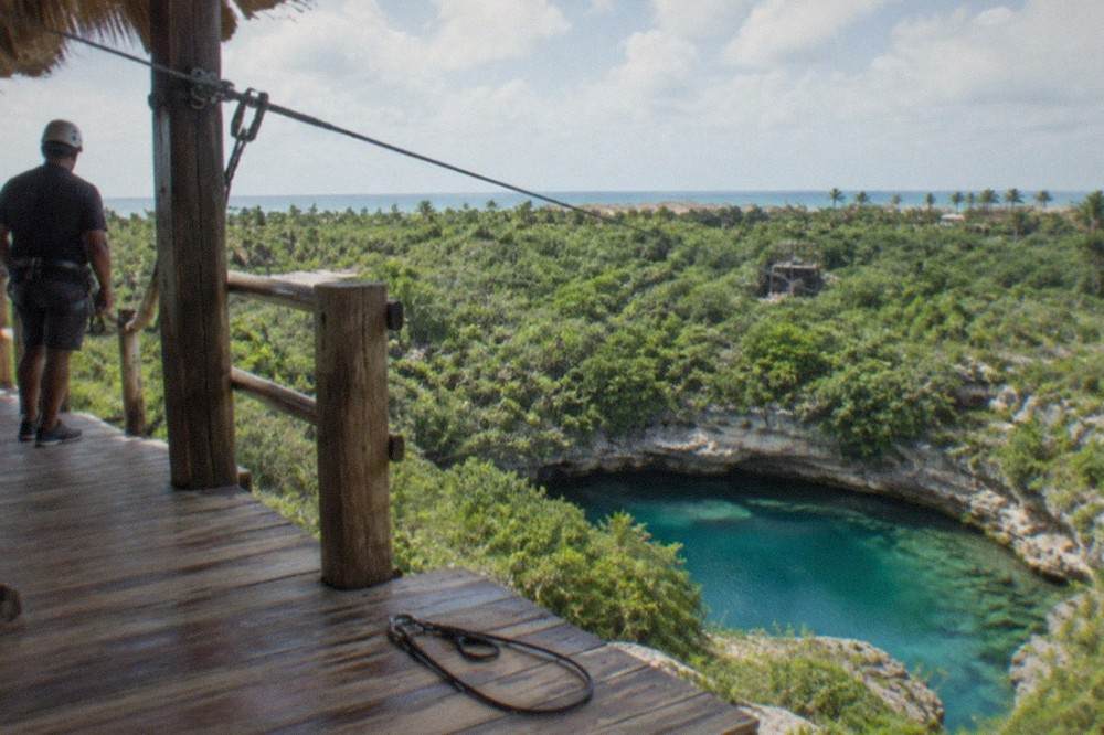 A zipline platform above green treetops inside Scape Park at Cap Cana