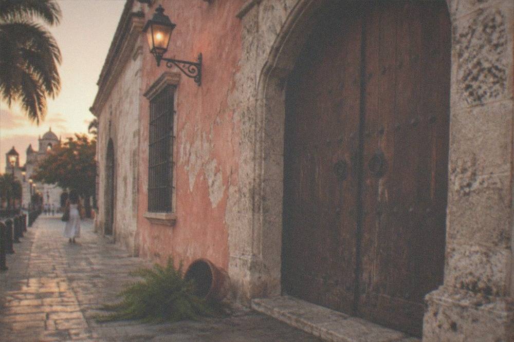 Wooden doors and a stone archway in a colonial building facade in Santo Domingo