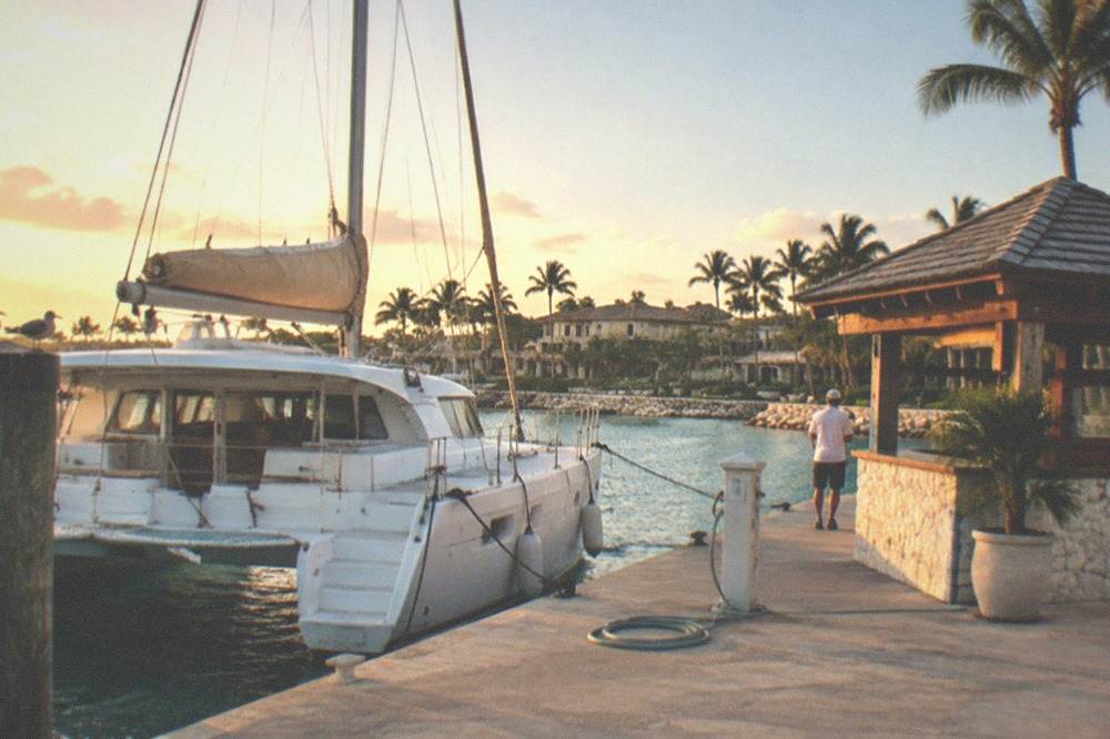 Catamaran moored beside a ticket and information kiosk at a Punta Cana marina