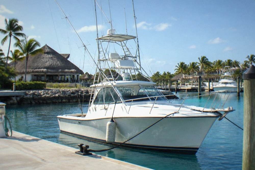 Private sportfishing boat at the dock with outriggers raised and clear morning sky